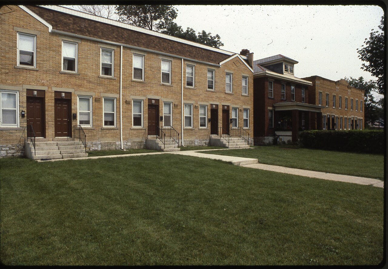 A brick single-family house with a front lawn